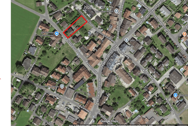 Building. Aerial view of a residential area with multiple houses, streets, and green spaces.