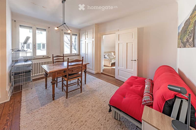 dining table with chairs, couch, rug, radiator, doors leading to bedroom, lamp