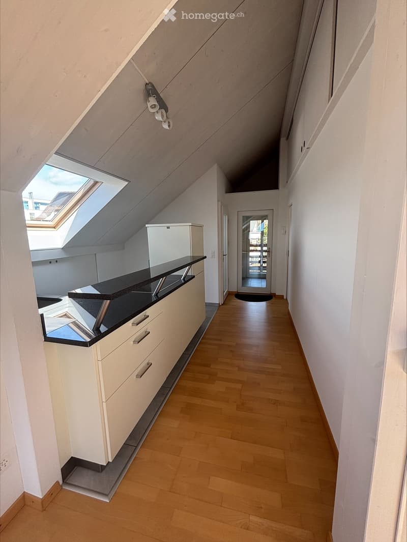 kitchen with wooden floor, white cabinets, black countertop, white refrigerator, skylight