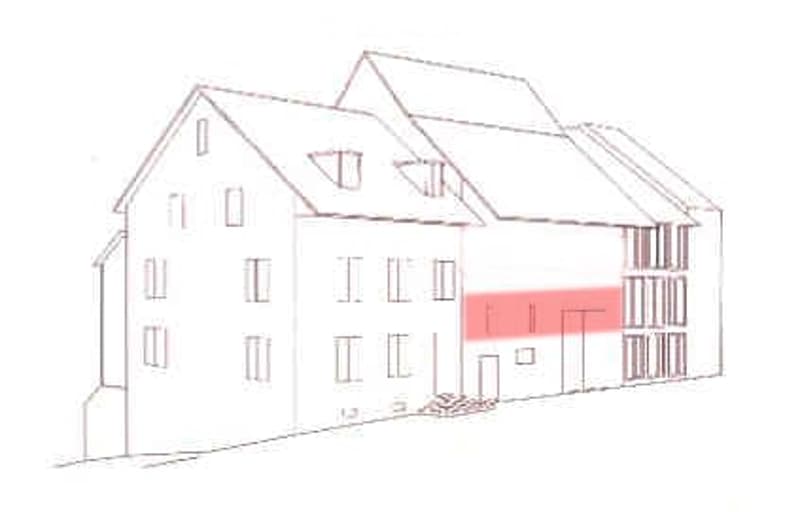 Floor plan of a multi-story residential building with multiple windows, a garage, and a highlighted section in red.