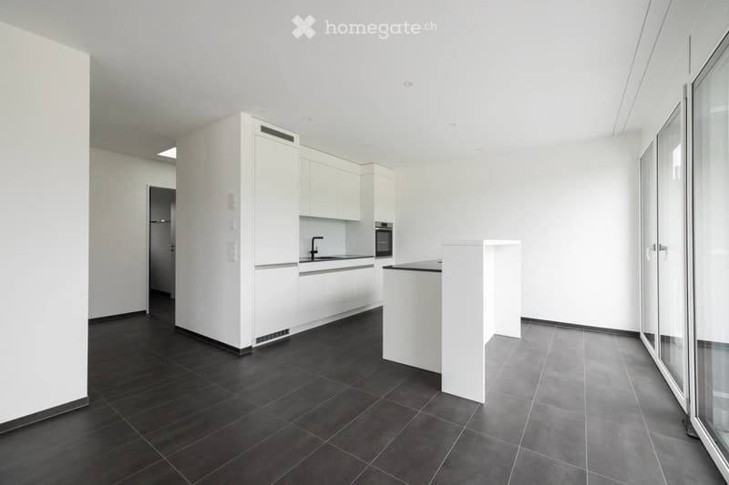 Modern kitchen with white cabinets, dark tiled floor, and a central island. Features include a refrigerator, oven, sink, and faucet.