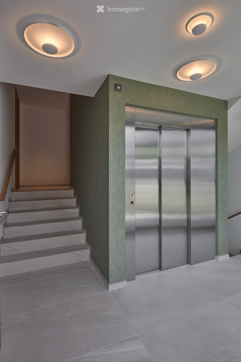 Lobby with elevator and staircase