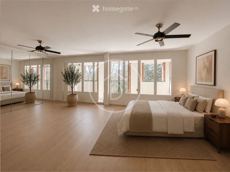 Spacious bedroom with wooden flooring, large bed with pillows and blankets, nightstands with lamps, potted plants, and large windows with a view.