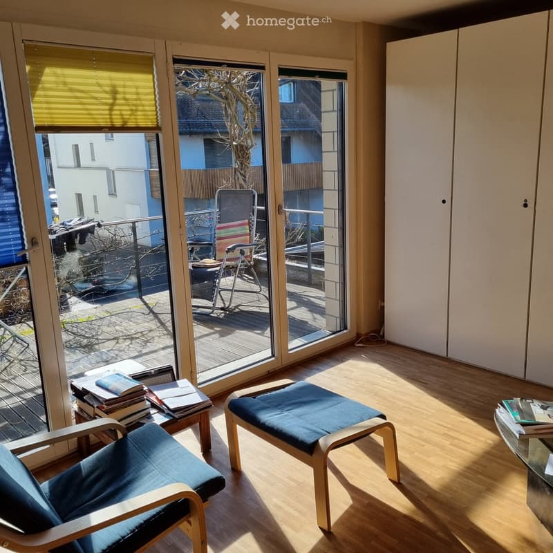 wooden floor, sliding glass doors, balcony, deck chairs, table, books, cabinet