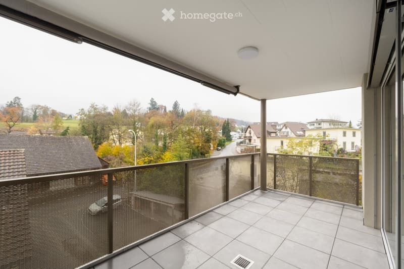 Balcony with metal railing, tiled floor, view of the street and houses