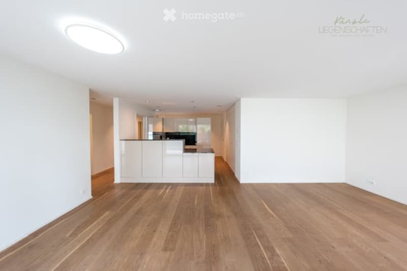 Completely empty room with white walls and wooden floor. No furniture or equipment.