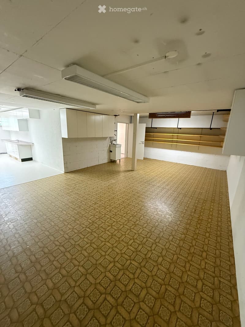 Empty room with tiled floor, white walls, and built-in cabinets. No furniture or equipment present.
