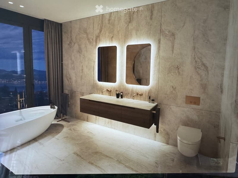 Modern bathroom with marble walls and floors, a freestanding bathtub, a double sink vanity with mirrors, and a toilet. The room features large windows with a night view.