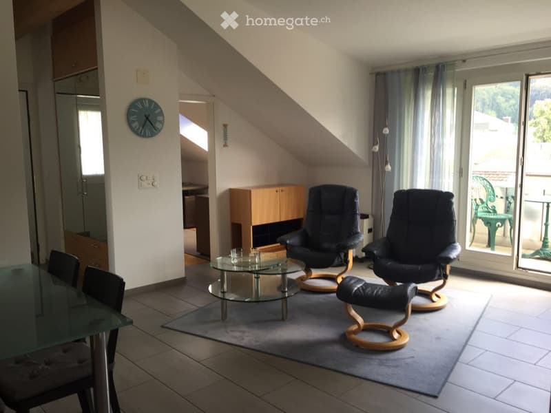 living room with chairs, table, glass top table, carpet, couch, cabinet, clock, sliding glass doors leading to balcony