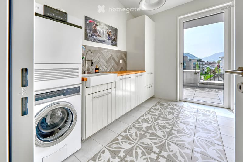 modern laundry room with washer and dryer, sink, cabinets, white tile floor