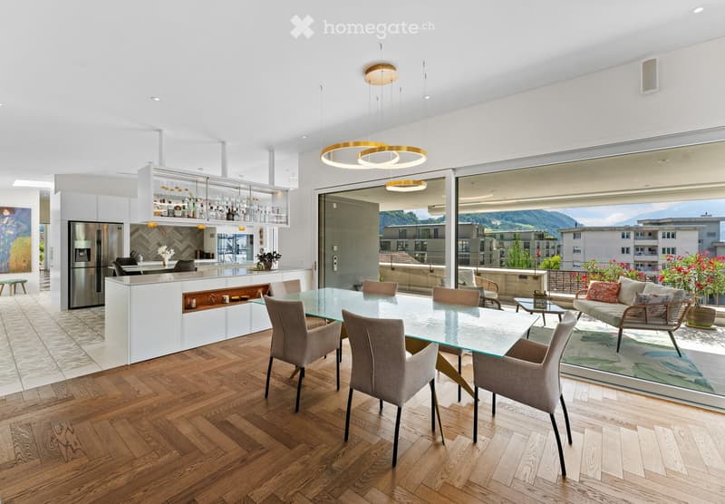white modern kitchen with island, refrigerator, wooden dining table, glass walls, wooden flooring
