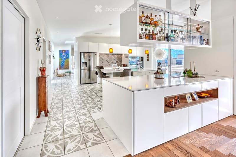 modern kitchen with central island, granite countertops, open floor plan, stainless steel appliances, large windows, wooden floor