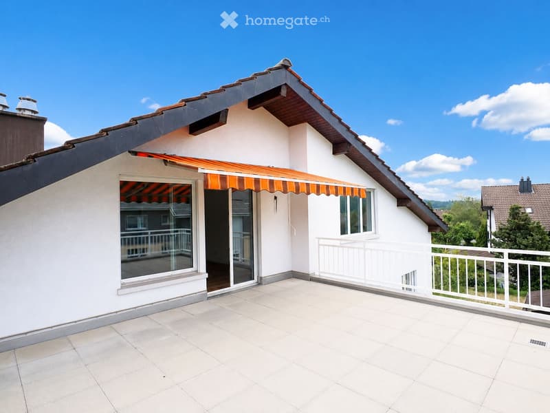 Balcony with tiled floor, white railing, and an orange awning extending from the building.