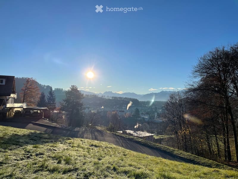 Wide view of hills, mountains, and a small town in the distance