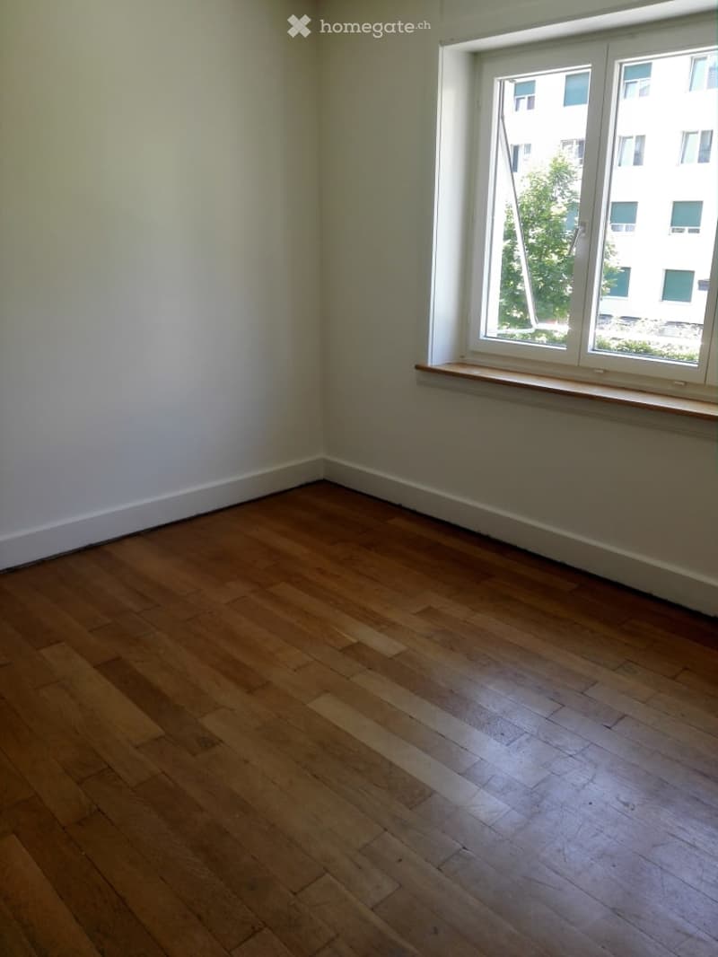empty room, hardwood floor, white walls, large window, open window, view of tree and building