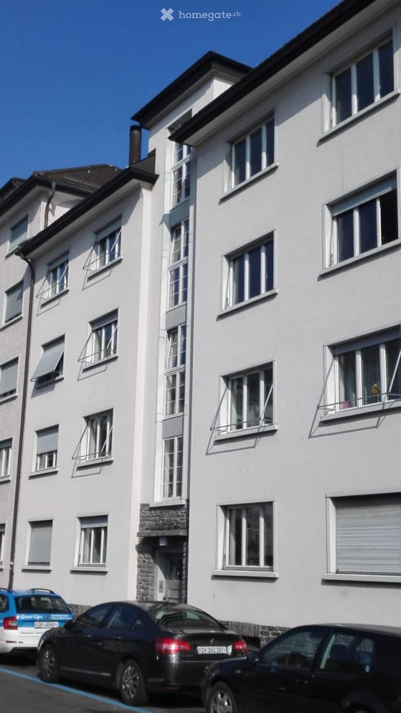 White painted building with 4 floors and 12 apartments, with balconies