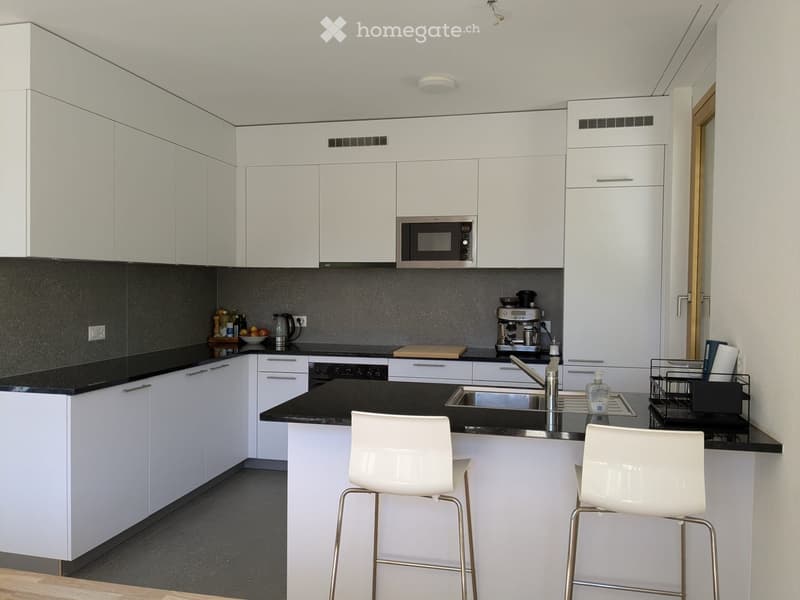 modern kitchen, white cabinets, black countertops, stainless steel appliances, white bar stools