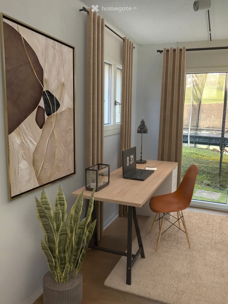 Furnished Room. A modern, well-lit room with a wooden desk, laptop, chair, lamp, plant, and a large picture frame on the wall. The room features large windows with curtains and a view of a garden.