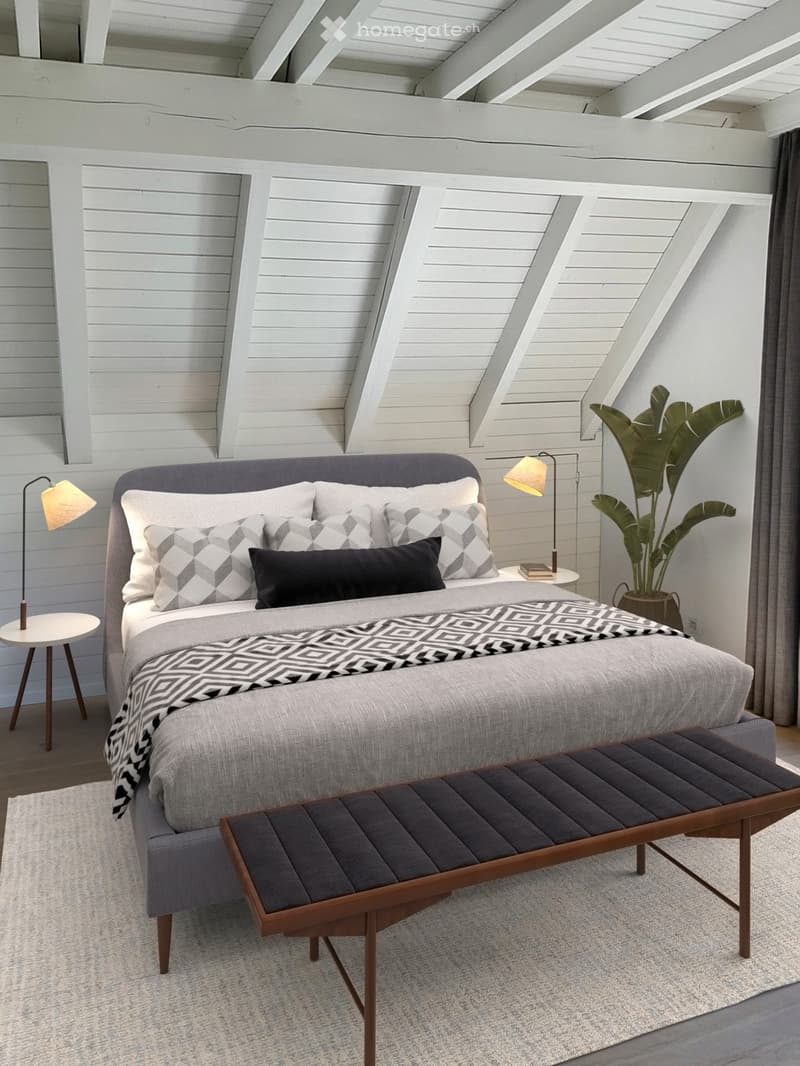 Bedroom. Modern bedroom with a grey upholstered bed, geometric patterned pillows and blanket, wooden bench at the foot of the bed, side tables with lamps, and a large leafy plant in a pot.
