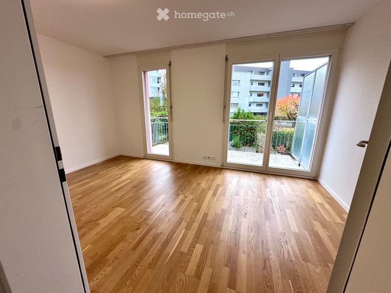 hardwood floors, sliding glass doors to balcony, white walls, empty room