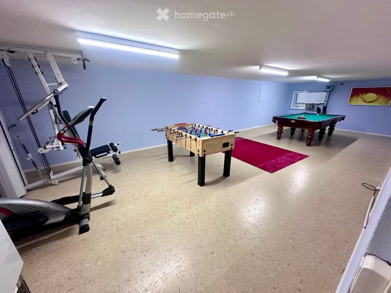 exercise equipment, foosball table, pool table, red rug