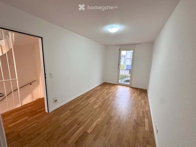 empty room, hardwood floor, white walls, sliding glass door to balcony, glass door to another room, wall switch, balcony railing