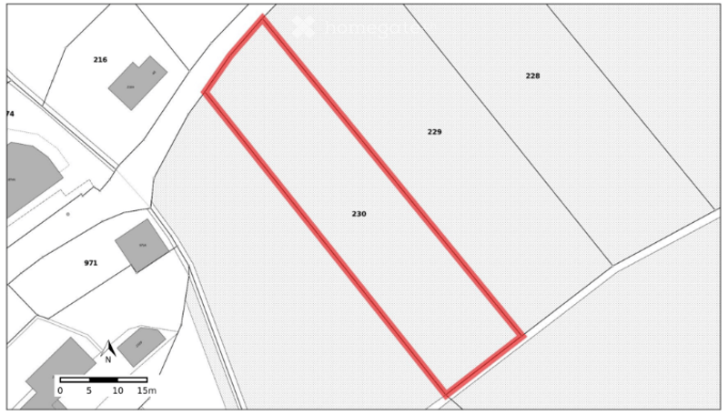 A floor plan showing a single rectangular plot of land outlined in red, surrounded by other plots marked with numbers. The plot is situated within a larger area with multiple adjacent plots and a north indicator at the bottom left.