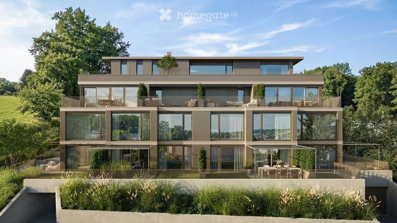 Modern two-story building with large windows, balconies, and outdoor seating areas, surrounded by greenery.