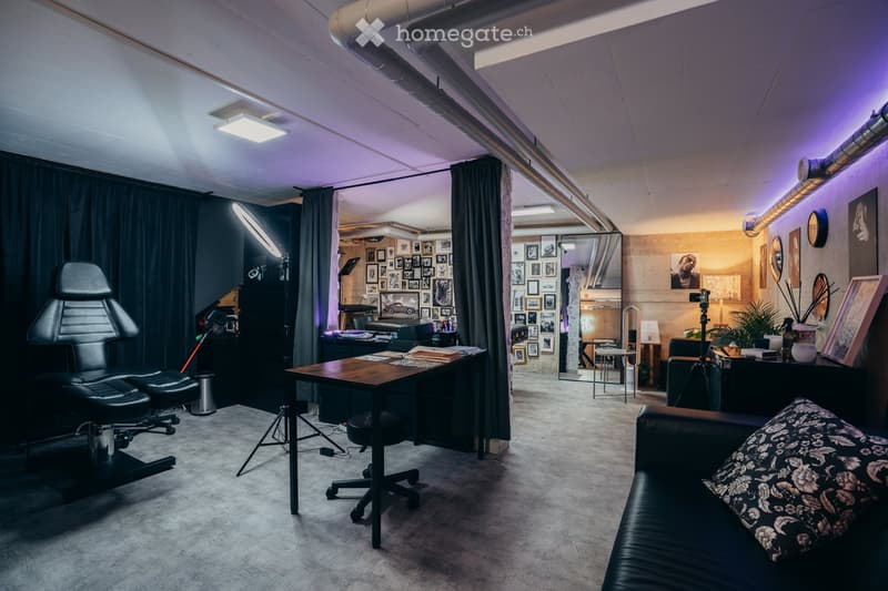 modern interior, leather couch, desk, black office chair, purple and white lights, table with books and files, several photo frames