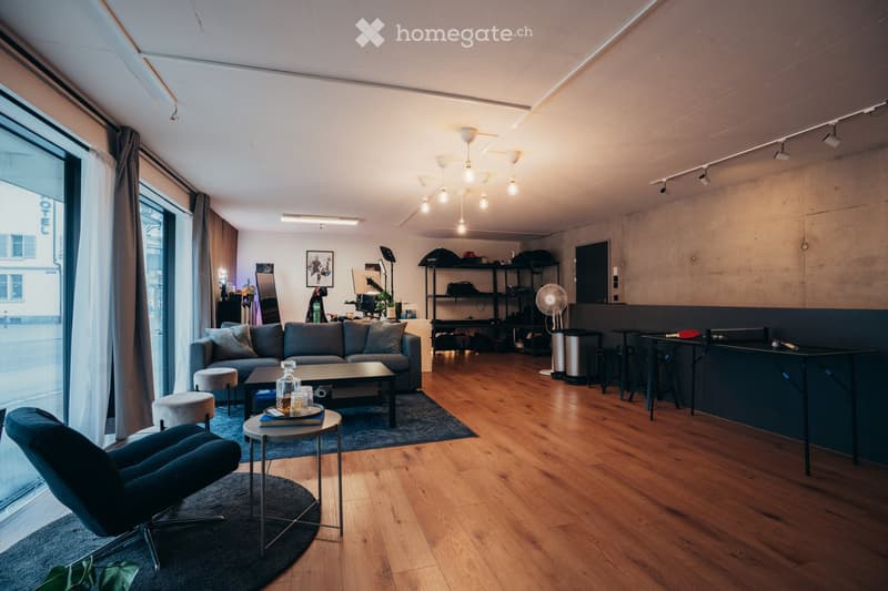 Wooden floor, open layout with living and dining areas, large windows, modern furniture, table tennis setup