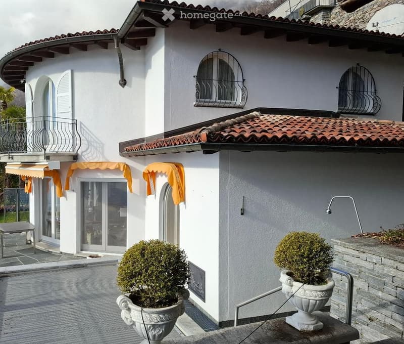 2 story house, white paint, red roof, balcony, patio, 3 windows, orange awnings