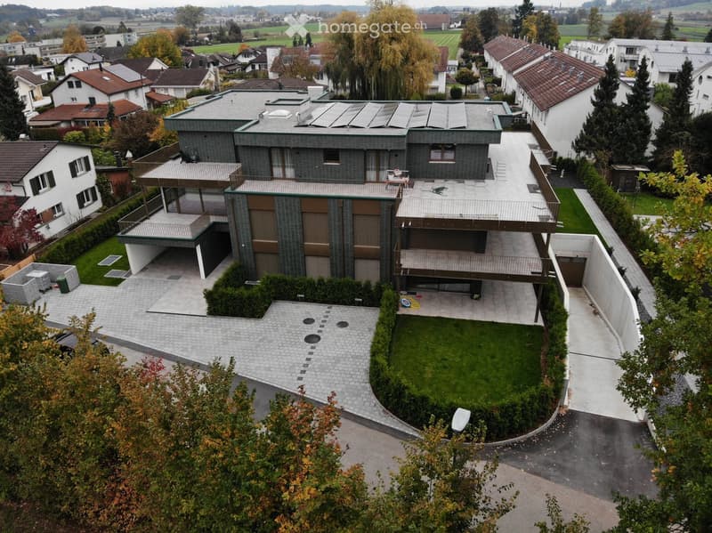 Modern house, large solar panels on the roof, swimming pool in the garden, garage, fenced garden, multiple balconies