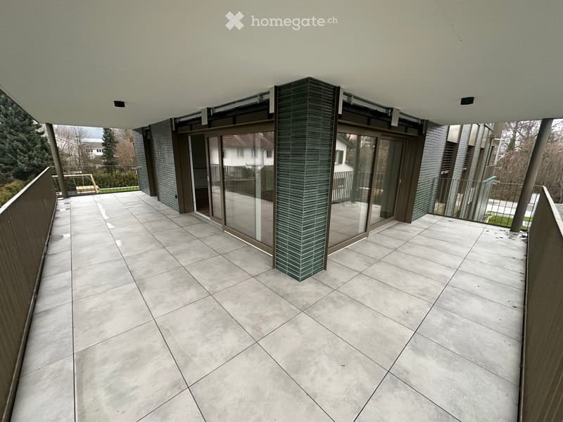 modern balcony, large glass walls, tiled floor, balcony railings, garden view