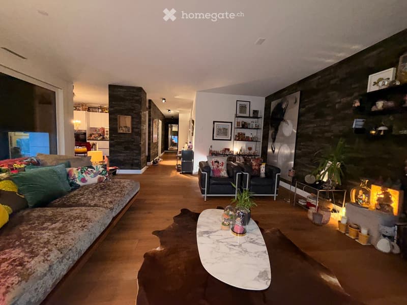 large couch, coffee table, fireplace, wooden floor, decorative items