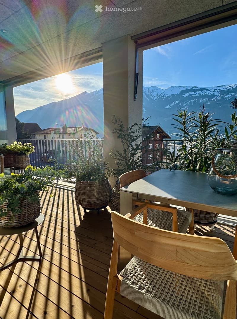wooden balcony, table, chairs, potted plants, view of mountains