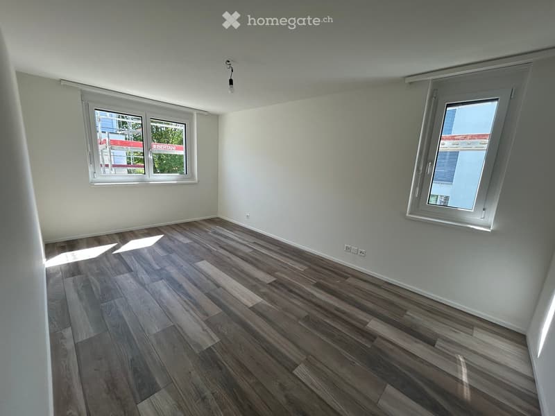 empty room, wooden floor, white walls, two windows, power outlets