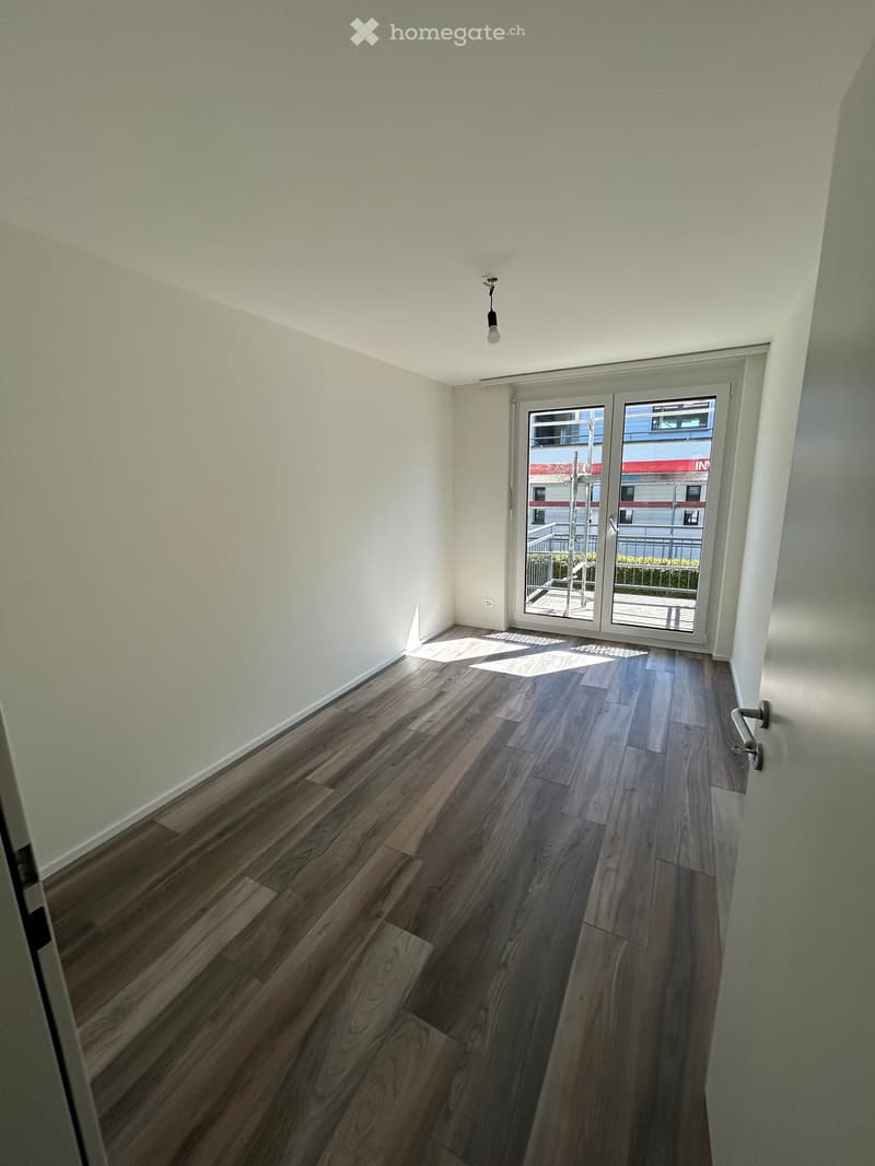 empty room, wooden floor, white walls, sliding glass doors, balcony