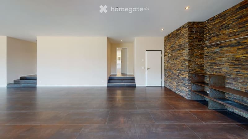 Open living area with a staircase, brick accent wall, tiled flooring, white walls, doorway, metal shelves