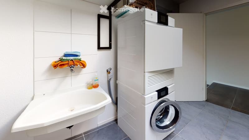 white ceramic sink, stackable washing machine and dryer, towel rack