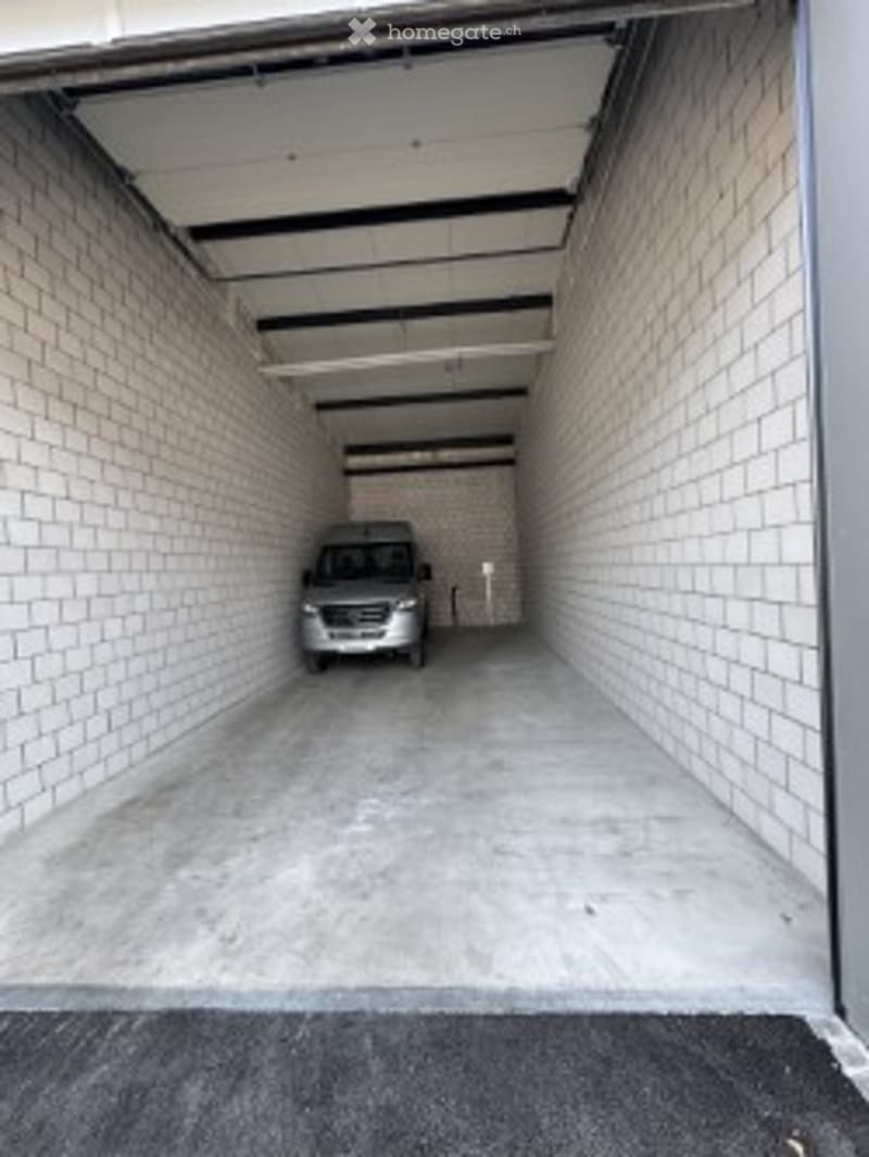 {"visible_features": ["Garage"], "type": "Garage", "objects": [], "description": "Clean, well-lit garage with concrete floor, white brick walls, and a parked car inside.", "localized_descriptions": {"EN": "Clean, well-lit garage with concrete floor, white