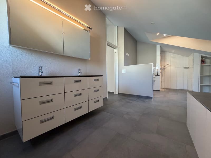 Modern bathroom with a double sink, sleek cabinetry, and a separate shower area.
