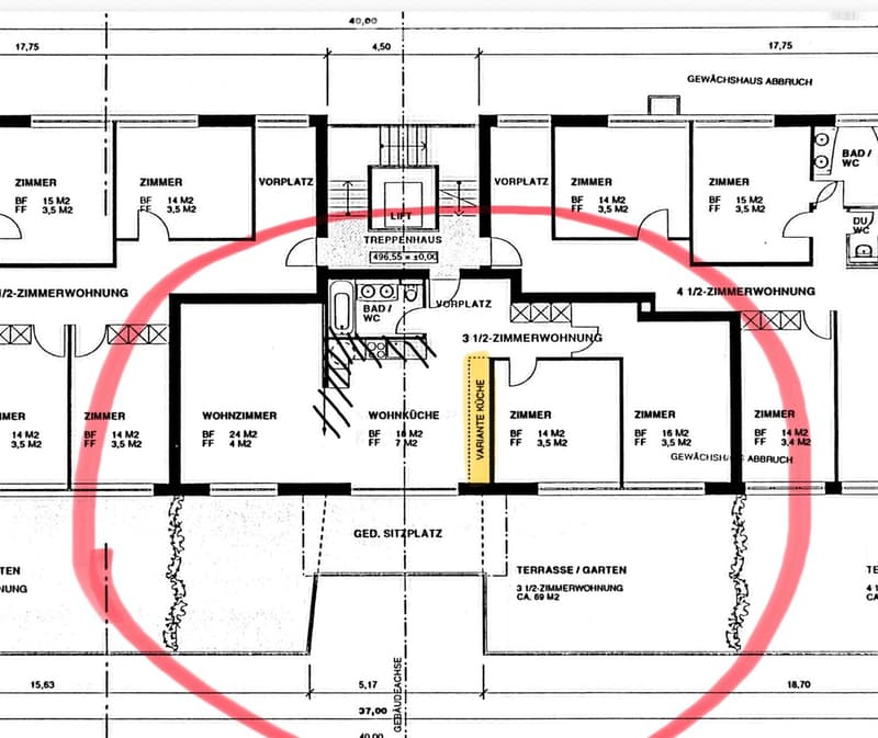 Floor plan showing multiple apartments with rooms labeled, including living room, kitchen, bedrooms, bathrooms, and a terrace/garden area.