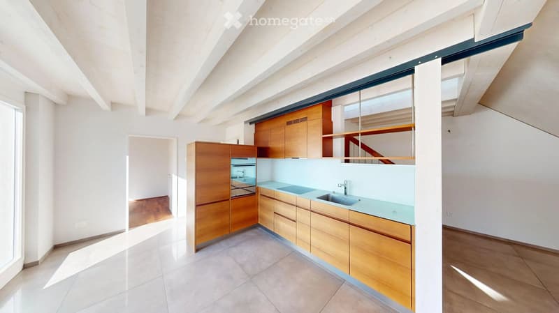 Modern kitchen with wooden cabinets, stainless steel appliances, and a light blue countertop.
