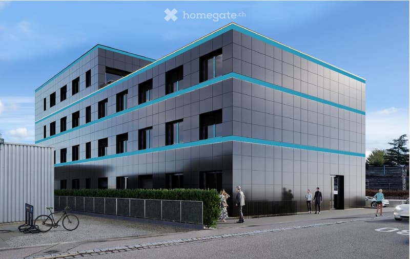Modern multi-story building with grey and teal facade, large windows, and a sleek design. The building has a contemporary architectural style with clean lines and a symmetrical layout.