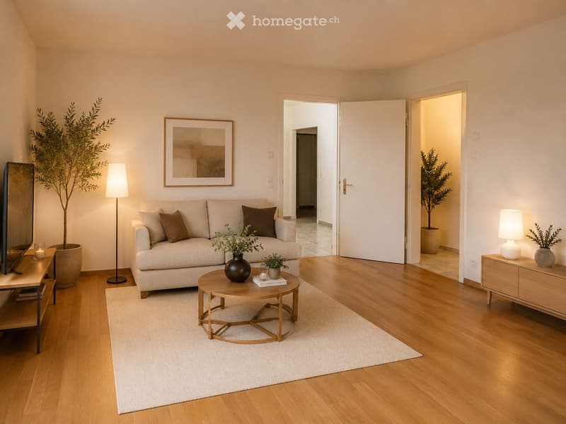 Modern living room with light-colored sofa, coffee table, floor lamp, side table, and decorative plants.