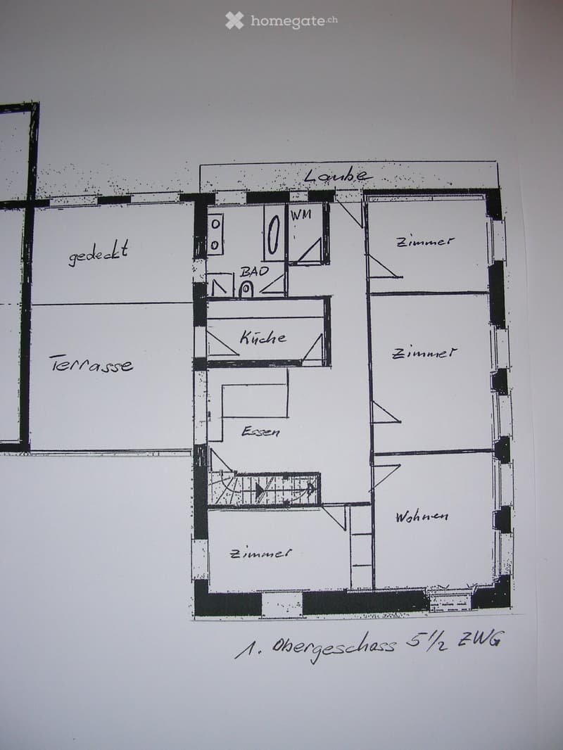 Floor plan of the upper floor showing a living room, kitchen, dining area, two bedrooms, and a bathroom. Includes a covered terrace.
