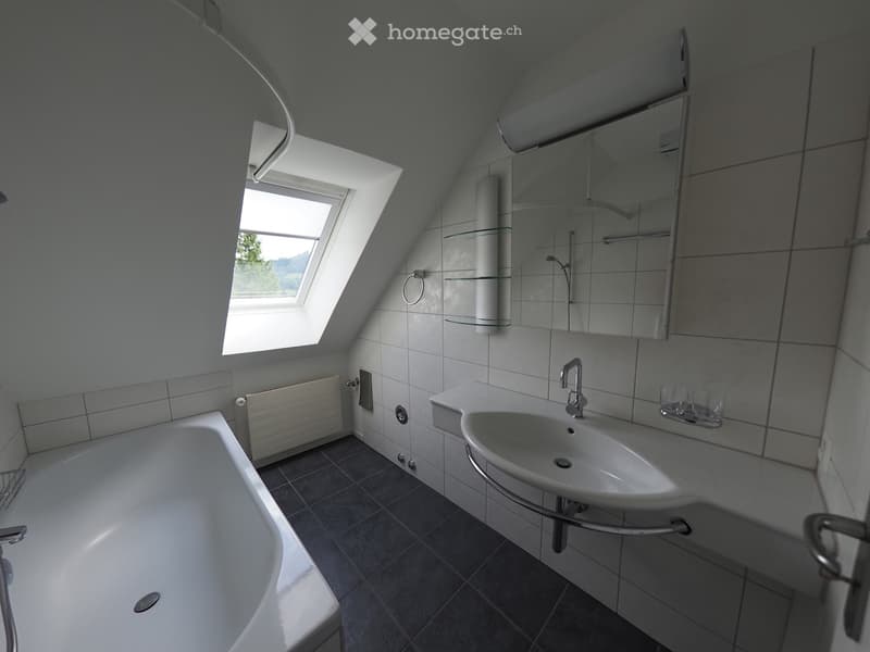 Bathroom with bathtub, sink, mirror, and window