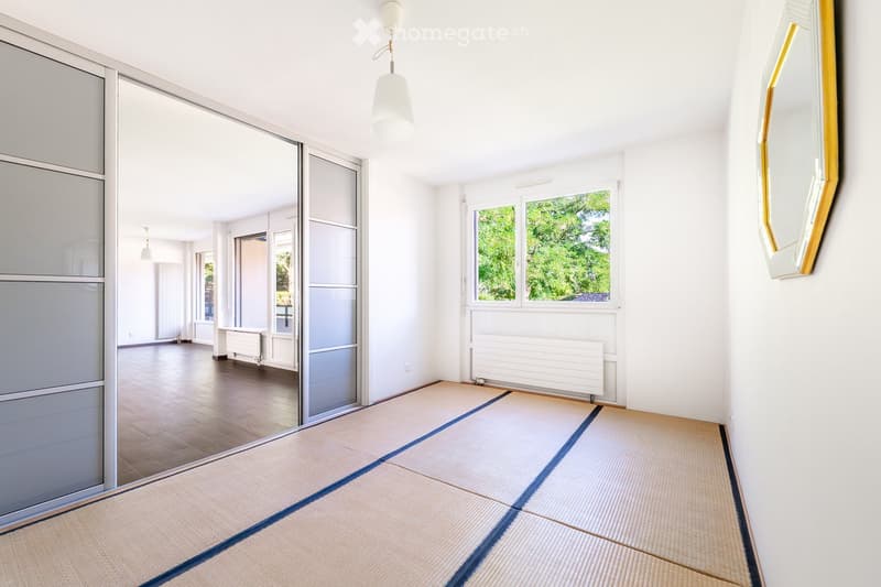 Unfurnished Room. Empty room with tatami mat flooring, large windows, sliding glass doors, and white walls.