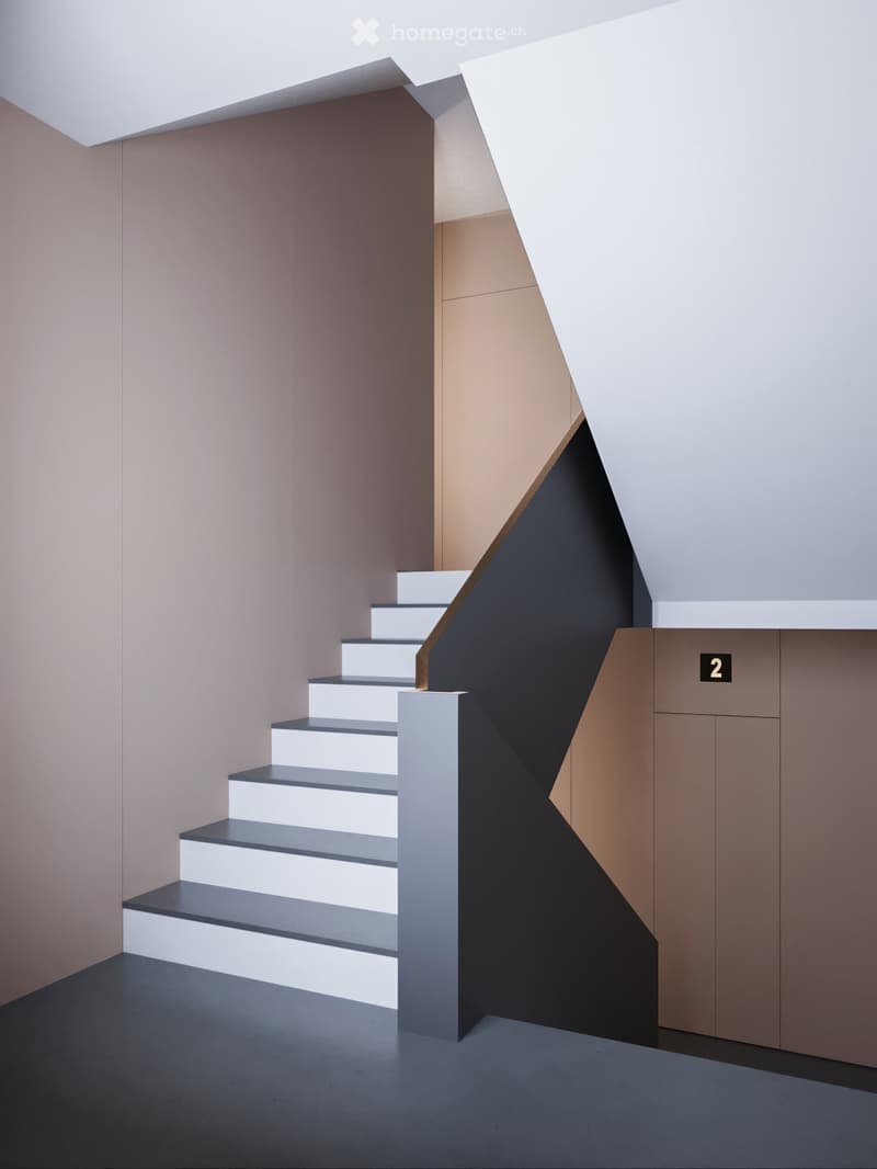 Sleek modern staircase, white and gray steps, black handrail, geometric design