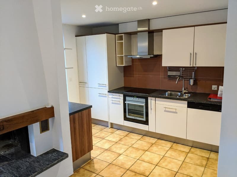 Kitchen. Modern kitchen with white cabinets, stainless steel appliances, and a dark countertop.